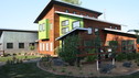 The Huber family values living simply and protecting the environment.&nbsp; Therefore, we wanted to build them a home that was true to their eco-friendly lifestyle.&nbsp; This resulted in their home being a Green Build, meaning that it saves water and energy, and conserves natural resources.&nbsp; It also uses salvaged materials or products made with a high recycled content, and reduces its overall impact on the environment.&nbsp; We began by using recycled building materials, such as wood, metal, copper & concrete.&nbsp; We also recycled the remains of their old home and turned them into mulch for their backyard.&nbsp; In addition, we gave them a wind turbine so they can use wind energy.&nbsp; This not only helps our environment, but will also save them up to 30% on their energy costs.&nbsp; The interior stairs are made from recycled timbers, and their flooring is cork.&nbsp; Even some of their furniture, such as the coffee table, was constructed from recycled materials!&nbsp; As you can see from all of these elements in the Huber family's home, the sky is the limit in building green!