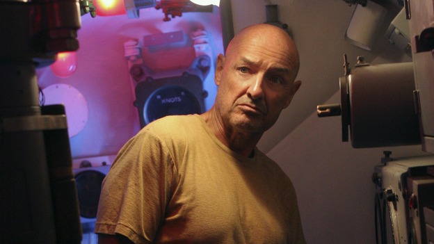 That Sinking FeelingJack made a deal with Ben to leave the island on a submarine. He'll return to save everyone else. But John Locke believes it would be a mistake to leave the island. So he blows up the sub. Ben realizes that John Locke has a oneness with the island. He takes him into a room where a man is being held hostage. That man is Locke's father. He's also the man responsible for putting him in a wheelchair years ago. This could be payback time.