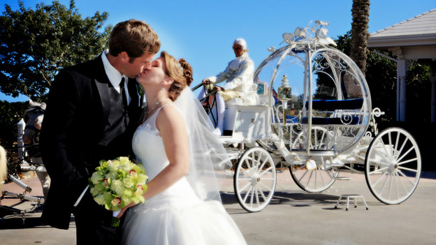 Melissa and Larry share a moment before riding away in Cinderella's Coach. www.disneyweddings.com
