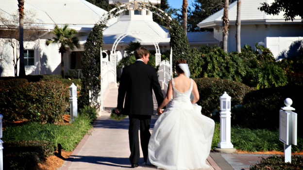 Melissa and Larry enjoy some private time crossing the bridge at Disney's Wedding Pavilion. www.disneyweddings.com